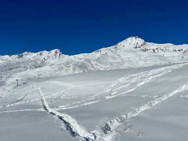 Wonderful winter hiking trails and traces in the fresh alpine snow cover of the Swiss Alps and over the tourist resort of Arosa - Canton of Grisons, Switzerland (Schweiz)