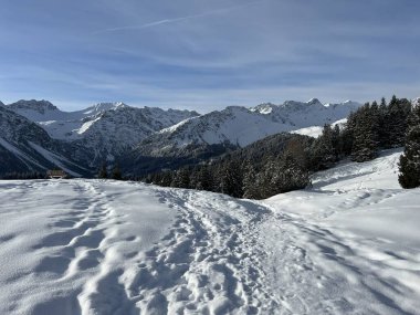 Wonderful winter hiking trails and traces in the fresh alpine snow cover of the Swiss Alps and over the tourist resort of Arosa - Canton of Grisons, Switzerland (Schweiz)