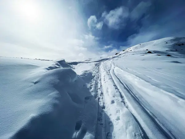 stock image Wonderful winter hiking trails and traces in the fresh alpine snow cover of the Swiss Alps and over the tourist resort of Arosa - Canton of Grisons, Switzerland (Schweiz)