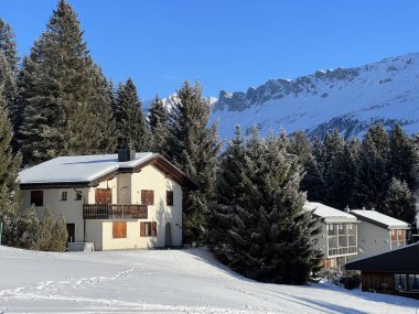 Swiss alpine holiday homes, mountain villas and holiday apartments in the winter ambience of the tourist resorts of Valbella and Lenzerheide in the Swiss Alps - Canton of Grisons, Switzerland (Schweiz)