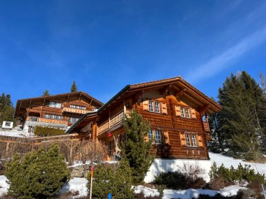 Swiss alpine holiday homes, mountain villas and holiday apartments in the winter ambience of the tourist resorts of Valbella and Lenzerheide in the Swiss Alps - Canton of Grisons, Switzerland (Schweiz)
