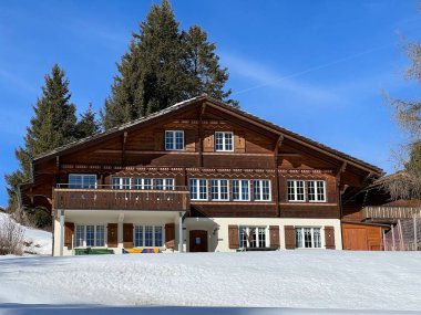 Swiss alpine holiday homes, mountain villas and holiday apartments in the winter ambience of the tourist resorts of Valbella and Lenzerheide in the Swiss Alps - Canton of Grisons, Switzerland (Schweiz)