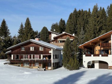 Swiss alpine holiday homes, mountain villas and holiday apartments in the winter ambience of the tourist resorts of Valbella and Lenzerheide in the Swiss Alps - Canton of Grisons, Switzerland (Schweiz)