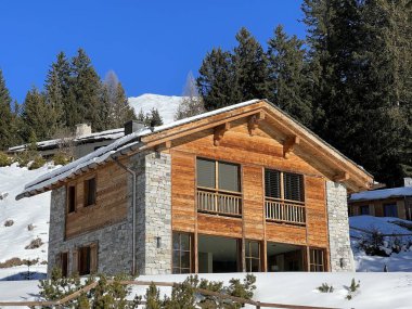 Swiss alpine holiday homes, mountain villas and holiday apartments in the winter ambience of the tourist resorts of Valbella and Lenzerheide in the Swiss Alps - Canton of Grisons, Switzerland (Schweiz)