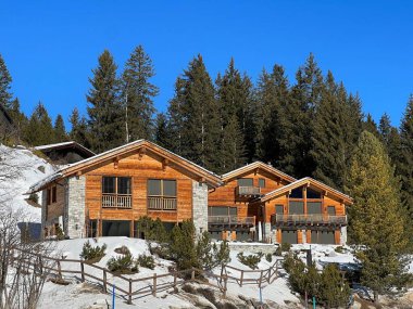 Swiss alpine holiday homes, mountain villas and holiday apartments in the winter ambience of the tourist resorts of Valbella and Lenzerheide in the Swiss Alps - Canton of Grisons, Switzerland (Schweiz)