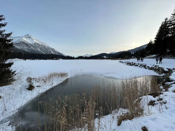 A typical winter idyll on the frozen and snow-covered alpine lake Heidsee (Igl Lai See) in the Swiss winter resorts of Valbella and Lenzerheide - Canton of Grisons, Switzerland / Schweiz