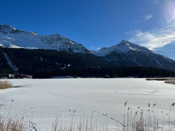 A typical winter idyll on the frozen and snow-covered alpine lake Heidsee (Igl Lai See) in the Swiss winter resorts of Valbella and Lenzerheide - Canton of Grisons, Switzerland / Schweiz