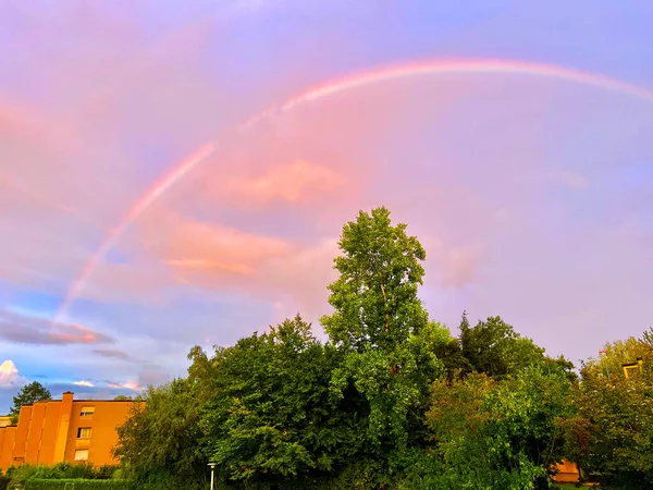 An evening rainbow in the evening sky and after a summer storm over a park in the Swiss city of Zurich (Zuerich) - Switzerland (Schweiz)