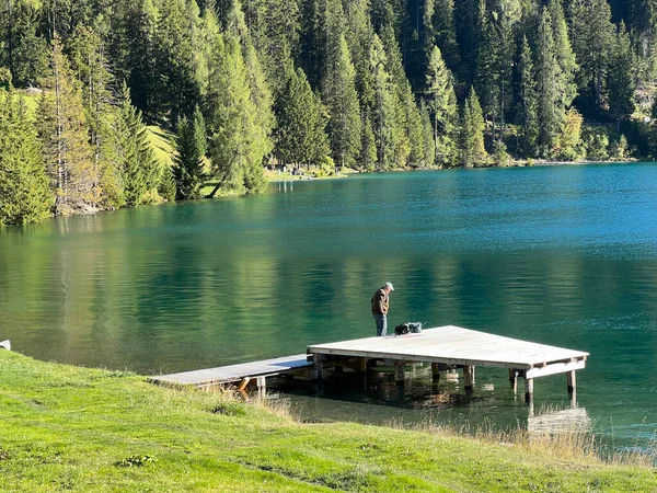 A famous Swiss mountain Lake Davos for sports and relaxation in the heart of the Alps (Davosersee oder Davoser See), Davos Dorf - Canton of Grisons, Switzerland (Kanton Graubuenden, Schweiz)