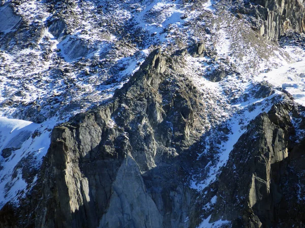 stock image Alpine rock Isla Persa next to the autumn remains of the Vardet da Grialetsch glacier and in the Albula Alps mountain massif, Zernez - Canton of Grisons, Switzerland (Kanton Graubuenden, Schweiz)