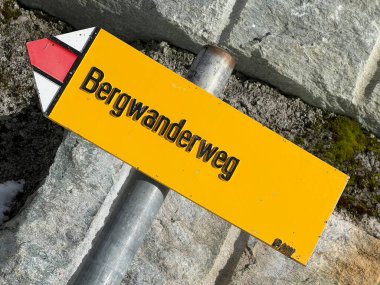 Mountaineering signposts and markings in the mountainous area of the alpine tourist resort Klosters and the massif of the Swiss Alps - Canton of Grisons, Switzerland (Kanton Graubuenden, Schweiz) clipart