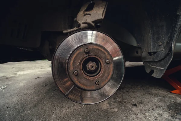 Old Disk brake and car service concept - Vehicle brake pad replacement service by hand of mechanic man in car, do it yourself, myself.