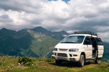 Mestia, Svaneti, Gürcistan - 12 Ağustos 2021: Mitsubishi Delica Uzay Gear yaz dağlarında köy yolunda. Delica, Mitsubishi Motors tarafından üretilen bir kamyon ve çok amaçlı araçtır..