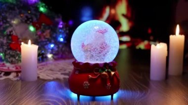 Noel Baba, kar ve ayıyla el sıkışın. Yeni yıl ve Noel. Şömine ve Noel ağacı süslemeleri. Yeni yılın sıcak ve rahat atmosferi. Yeni yıl balosunda kar.
