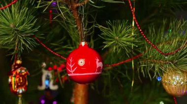 Kırmızı top. Noel ağacı süslemeleri asan adam. An 'ın elleri. Noel ağacı süslemeleri. Yeni yıl ve mutlu Noeller. Noel ağacında çelenkler ve oyuncaklar.