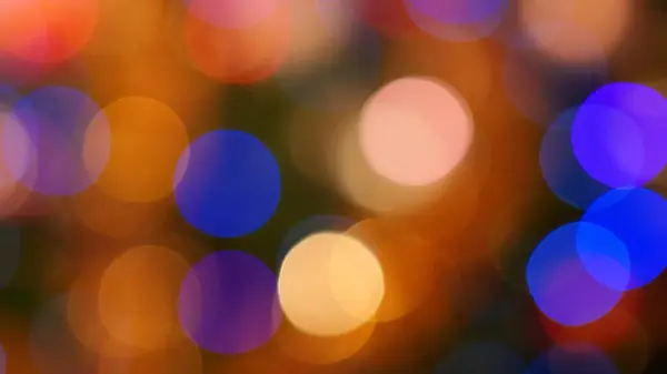 Sarı, Turuncu ve Mavi Odaklı Renksiz Çemberlerle Soyut Masaüstü Duvar Kağıdı. Yumuşak ve Rüyalı Bokeh Efekti Sıcak ve canlı bir Arkaplan Oluşturuyor.