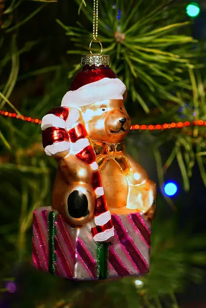 Ayı. Mutlu Noeller ve mutlu yıllar. Noel Ağacı Oyuncak Süslemeleri. Işıklar ve çelenklerle süslenmiş, Eşsiz Noel Ağacı 'ndaki Şenlikli Sahne. Sıcak Tatil Kartpostalı