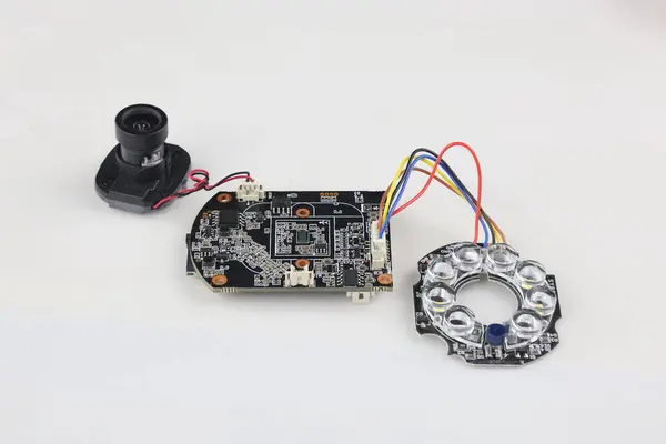 The image prominently displays the individual parts of a smart bulb camera, including the bulb housing, internal circuit board, camera module, and LED array.