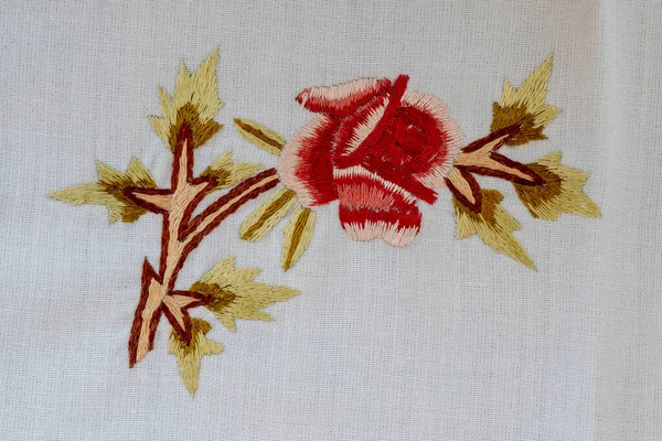 Cross-stitch with red floral pattern . Cross-stitch art. Handmade. etamine. Cross-stitch painting.