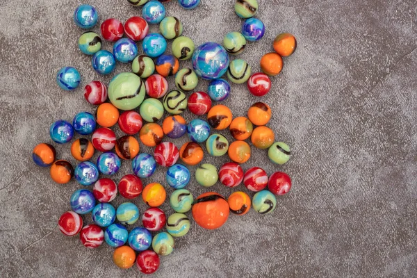 Glass colored marble balls , glass balls isolated on gray background . Children\'s play equipment.