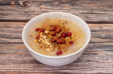 Traditional Turkish Dessert Aure or Noah Pudding in glass bowl. Conceptual image of the Day of Ashura in the Islamic Calendar.