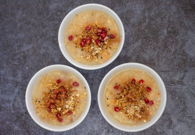 Traditional Turkish Dessert Aure or Noah Pudding in glass bowl. Conceptual image of the Day of Ashura in the Islamic Calendar.