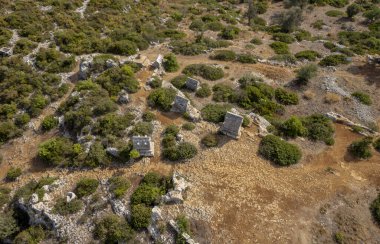 Simena (Kalekoy) ancient ruin site with sarcophagus by historic Simena castle, Turkey by Kekova islands.
