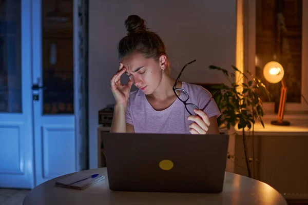 여자가 앉아서 집에서 컴퓨터를 안경을 통으로 고생하고 — 스톡 사진