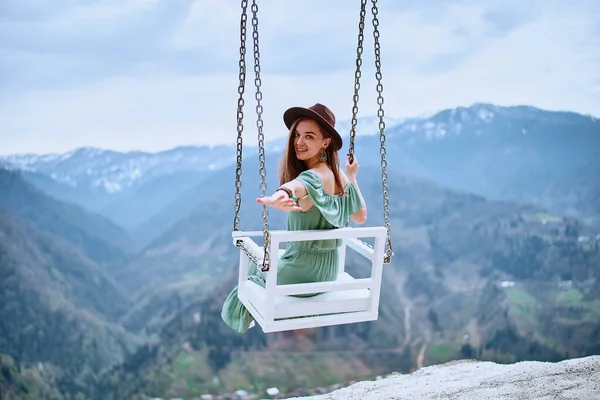 stock image Young free happy boho woman traveler enjoying of swinging on a heavenly swing and mountain view. Calm and quiet wanderlust concept moment when person feels happiness and freedom