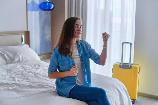 Satisfied Smiling Joyful Traveler Woman Sitting Bed Hotel Bedroom Check Stock Photo