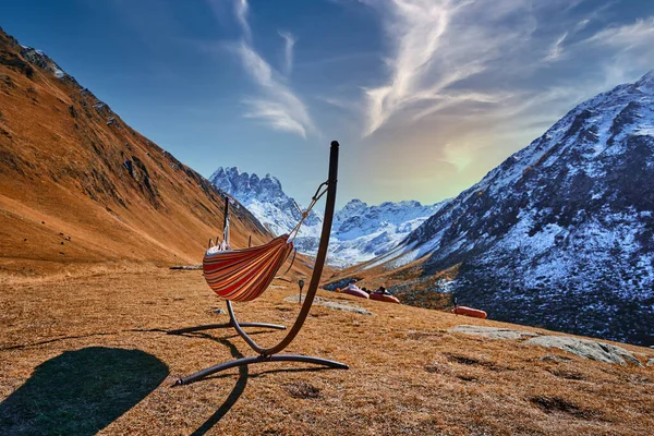Hammock for a relaxing, calm peaceful outdoor recreation with a view of the mountain range in the mount valley in Juta, Georgia