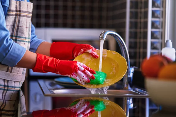 Домохозяйка Фартуке Красных Защитных Резиновых Перчатках Моет Посуду Дома Кухне — стоковое фото