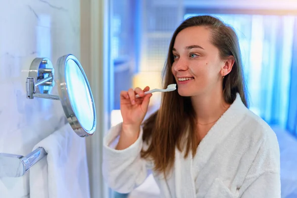 Young Beautiful Happy Girl Wearing Soft White Bathrobe Brushing Her — Stockfoto