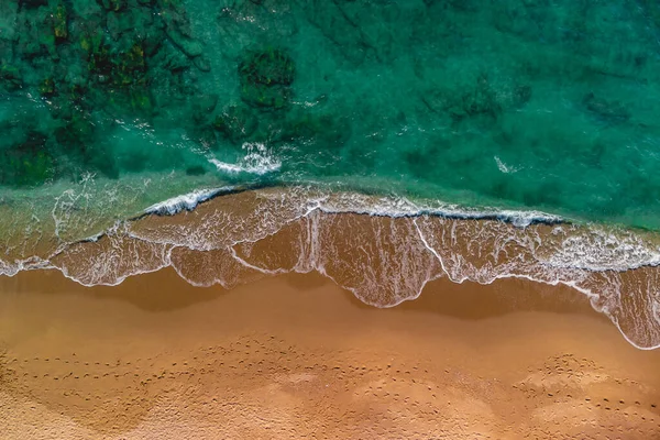 Top view of malachite emerald aquamarine water and sandy beach. Drone photo, sea green color