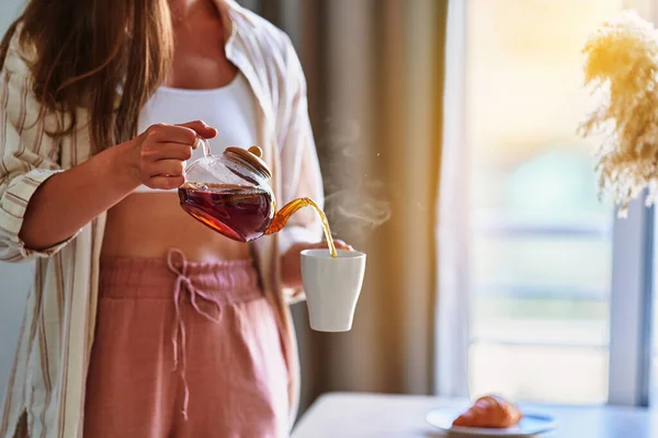 Woman Pouring Hot Aromatic Black Tea Cup Glass Teapot Home — Stock Photo, Image