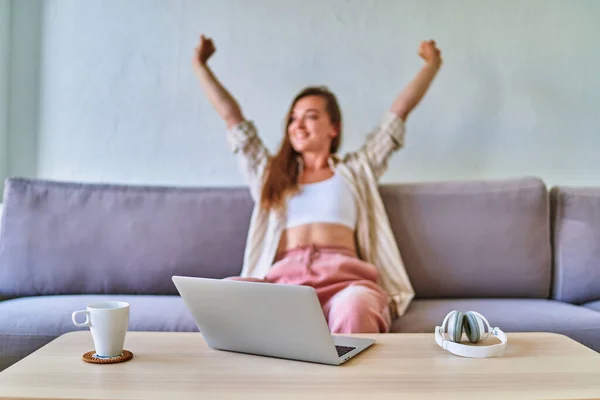 stock image Young smart busy modern girl relaxing on the couch after long remote working online at the computer 