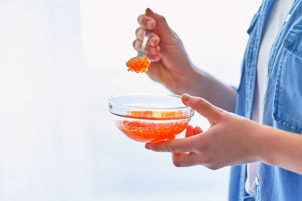 Female Hands Holds Glass Bowl Spoon Red Salted Caviar Omega — Stock Photo, Image