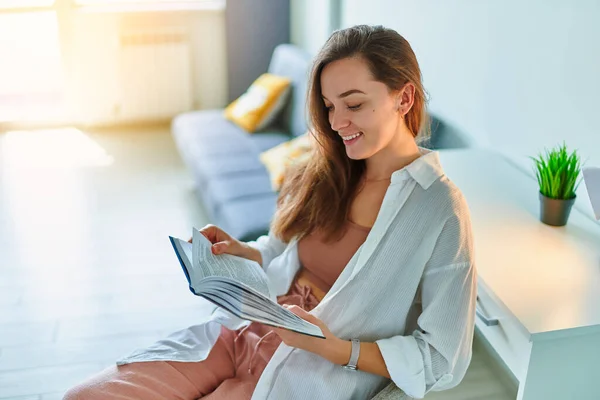 stock image Smiling happy woman reading book 