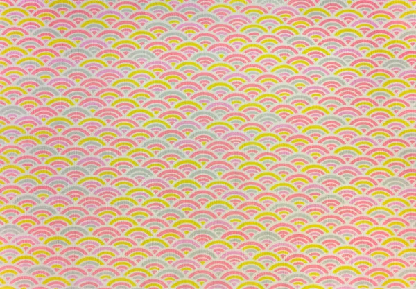 Highly detailed texture background of a traditional japanese furoshiki cloth printed with a modern and colorful geometrical seamless design depicting rainbow or waves shaped pattern called Seigaiha.