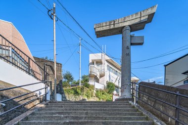 nagasaki, kyushu - dec 11 2022: Stone stairs leading to the remains of the atomic bomb-damaged torii arch of the Sanno shinto shrine which only one pillar survive the devastation of the blast.