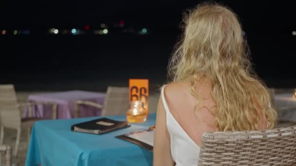 Blonde Woman Cafe Ocean Night Looks Restaurant Menu Chooses Dish — Stock Video