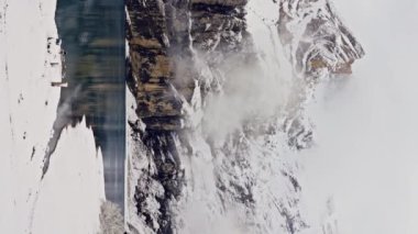 Oeschinensee Gölü karlı dağlar ve kayalarla çevrili, İsviçre. Göldeki dağların ayna yansıması. Dikey görünüm. Yüksek kalite 4k görüntü