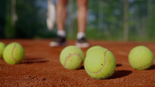 Close Tennis Balls Court Blurred Background Tennis Players Legs Make — Stock Video