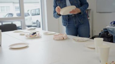 Konferans odasında pasta ve kağıt tabaklarla sıradan bir ofis toplantısı. Kutlamaya hazır..