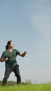  Ağır çekim. Şaşırtıcı bir doğal ortamda, yetenekli bir dövüş sanatçısı olağanüstü bir tekniği olan yüksek bir tekme atar.