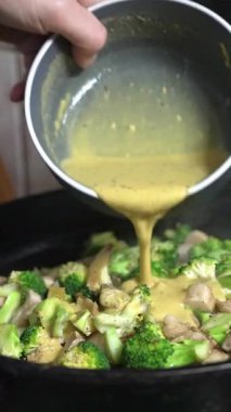 Taze brokoli ve leziz tavukla dolu renkli bir yemek. Tatmin edici bir yemek için lezzetli bir sosla kaplanmış.