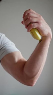 Bu yakın plan sanat eserinde canlı sarı bir muzu tutan bir el büyüleyici bir sanatsal ifade sergiliyor.