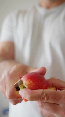 Bir elmayı ustalıkla kesen kişinin detaylı bir yakın çekimi, çeşitli temel mutfak tekniklerini vurguluyor.