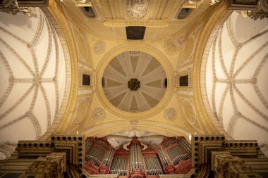 View from below of the dome and part of the organ of the cathedral of Santa Maria in Murcia, Spain of baroque style and artificially illuminated