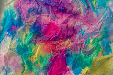 Texture created with napkin paper with multicolored liquid watercolors creating a gradient and rainbow effect